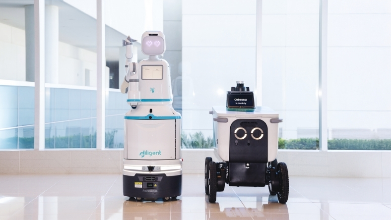 Hospital service robots standing in a clinical hallway