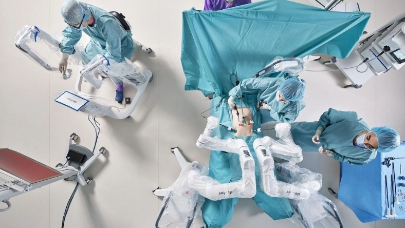 Surgeons use a robotic system during an outpatient surgical procedure