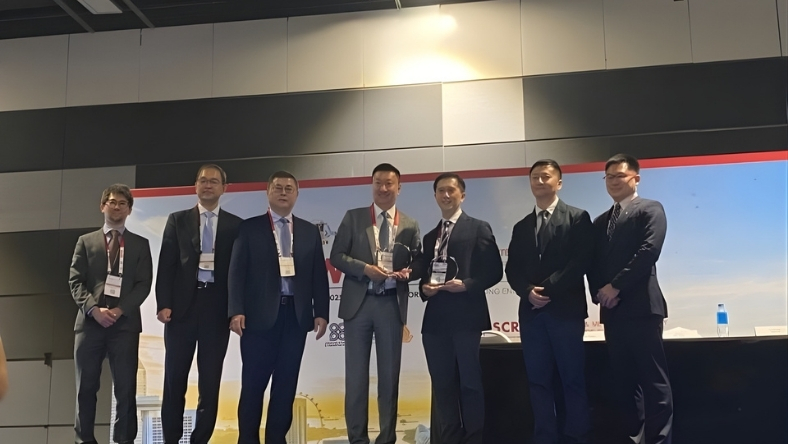 Medical technology executives stand on stage holding awards during surgical AI partnership event