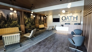 Modern surgical center reception area with the Oath Wharf logo displayed on the wall behind the desk